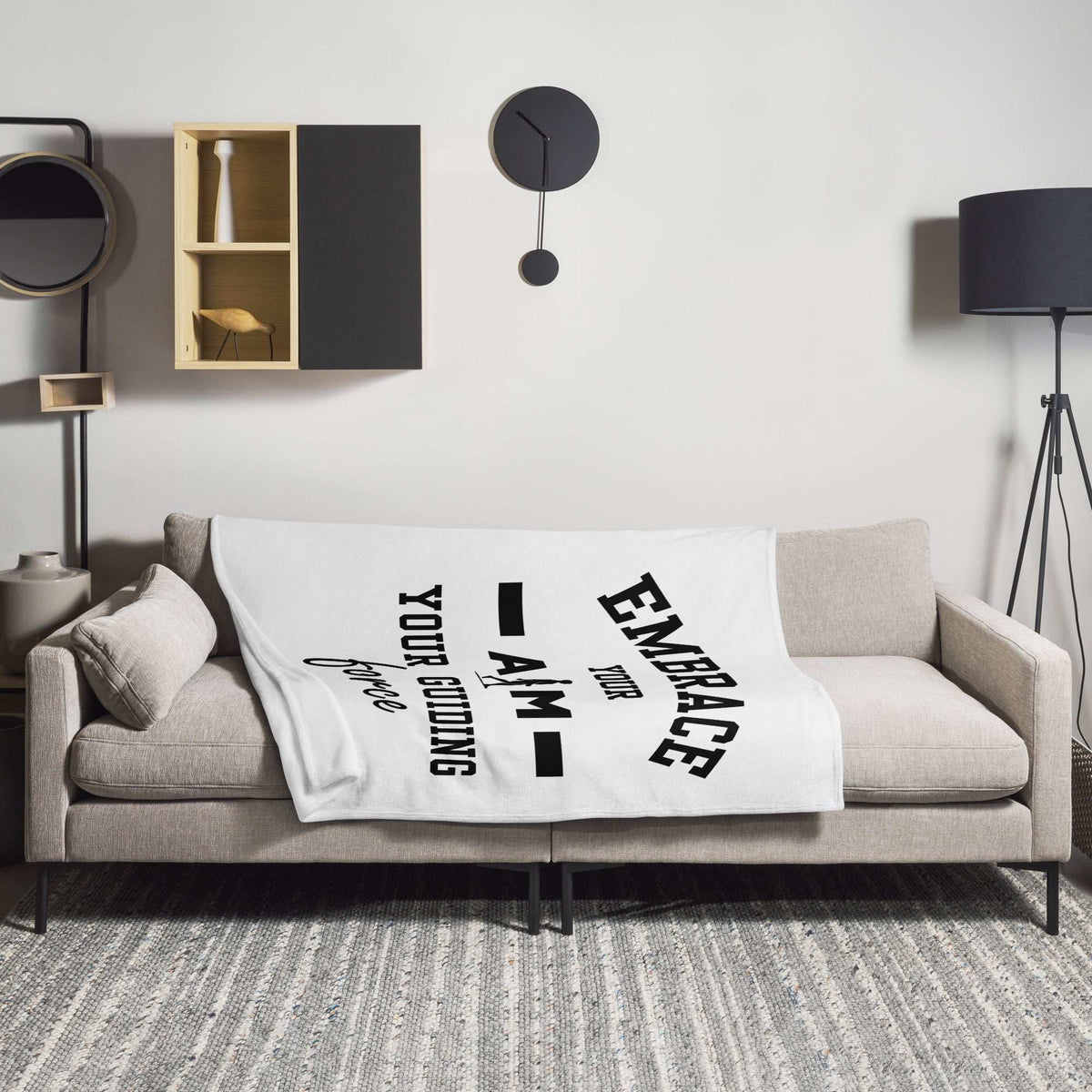 A cozy AIM Attitude throw blanket featuring the "Embrace Your AIM" design, soft fabric perfect for relaxing at home.