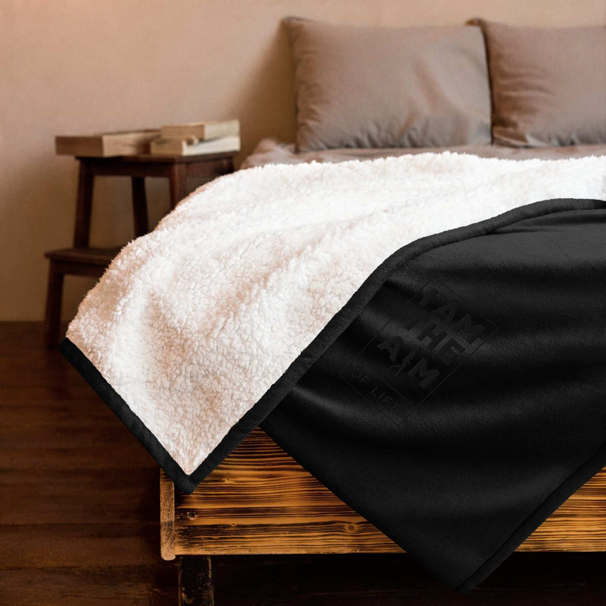 A plush AIM ATTITUDE Sherpa blanket with "I AM The AIM of Life" embroidered design, soft and cozy for warmth and comfort.