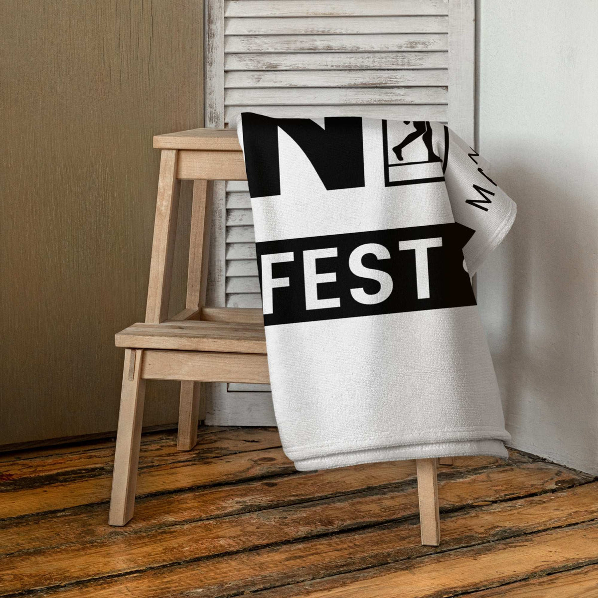 AIM ATTITUDE Manifest towel with bold design, soft fabric, and vibrant colors displayed on a white background.