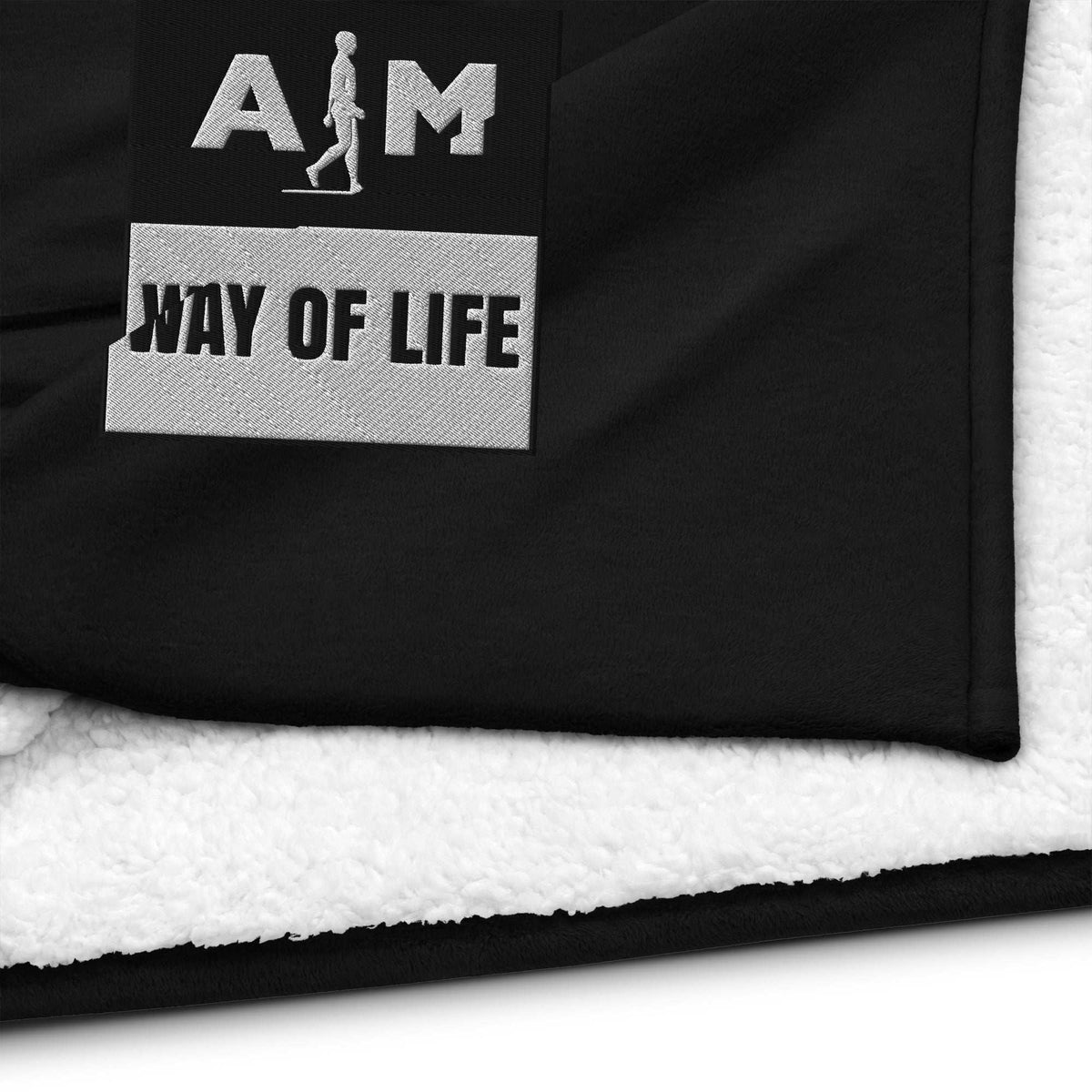 A soft, plush AIM Attitude Way of Life sherpa blanket with a cozy textured surface, ideal for warmth and comfort.